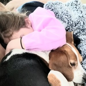 Girl crying into dog