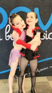 Sisters hug each other at dance competition