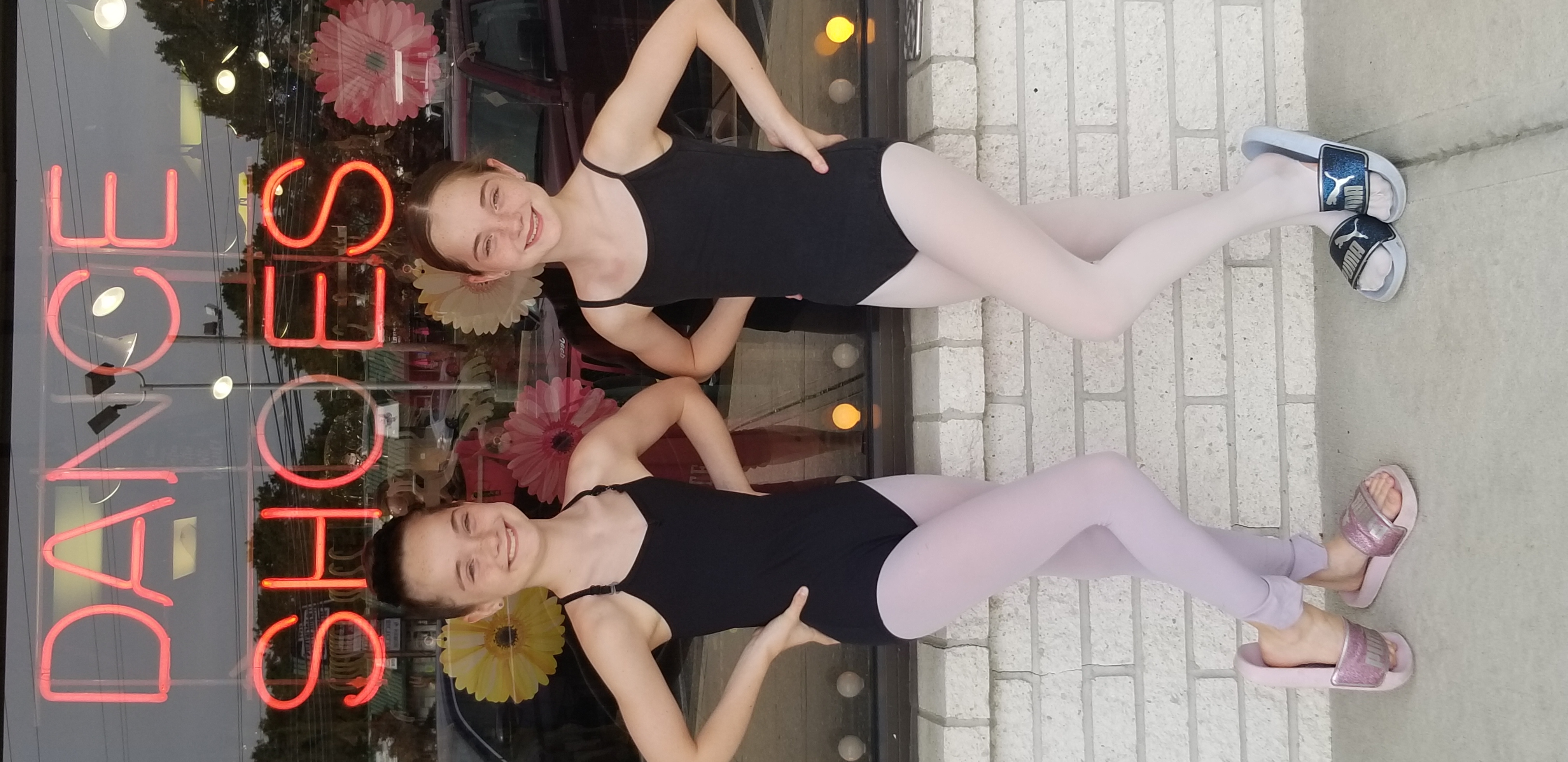 Girls in front of a dance supply store